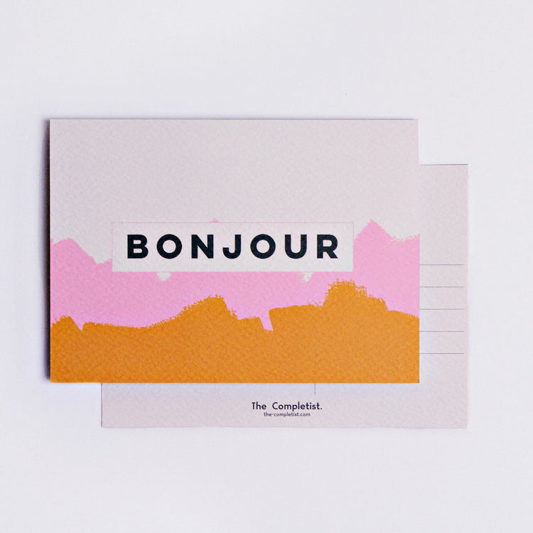 The completist pink mustard bonjour brushstroke postcard